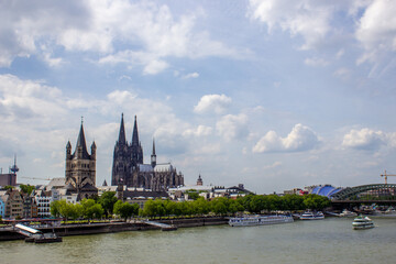 Fototapeta premium Cityscape of Cologne with Hohenzollern bridge, cathedral, Saint Martin church and Rin river in Germany