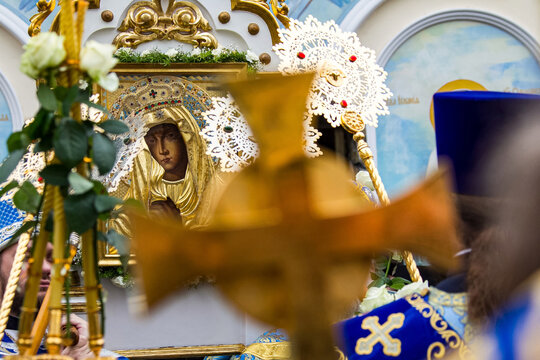 Blurred (out of focus) cross on the background of the icon of the Mother of God in the Orthodox church during the divine liturgy. The concept of Orthodoxy.