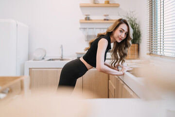 happy woman doing push up kitchen. smiling determined healthy concept woman control exercising flexible body to build muscle. beautiful woman training energy build muscle using body balance technique