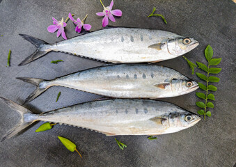 Selective focus of Doublespotted queenfishFish decorated on a wooden pad.