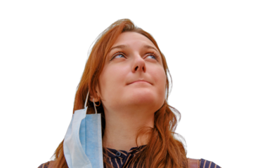 A woman with a mask removed after the end of the coronavirus quarantine, a close-up portrait of a red-haired woman, isolated on a white background. Copy space for text