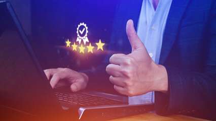 Businessman hand shows the sign of the top service Quality assurance 5 star with thumb up , Guarantee, best product, Standards, ISO certification and standardization concept.