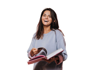 Beautiful girl in casual sweater with loose hair leafs open book on transparent background and laughing, Enjoying new book. Happy people concept. Beautiful young woman reading book. Candid emotions. - obrazy, fototapety, plakaty