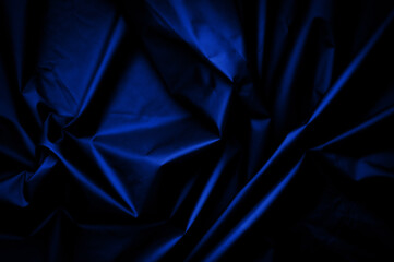 blue nylon texture. minimalist and elegant crumple textile. simple dark background