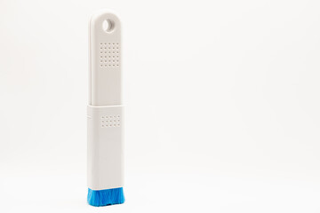 close-up of a plastic extending PC and IT dush brush with blue nylon bristles 