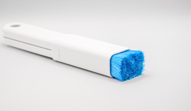 close-up of a plastic extending PC and IT dush brush with blue nylon bristles 