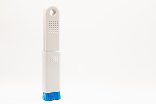 close-up of a plastic extending PC and IT dush brush with blue nylon bristles 