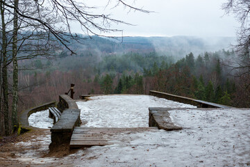 Misty scene of forest and valley in mountain of Paradise (Gleznotaju) in early January in Sigulda...