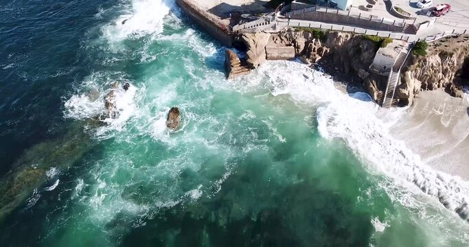 Aerial footage over the Children's Pool and sea wall in La Jolla, California