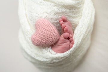 Close-up of unrecognizable cute baby shaking feet while lying in bed, innocence concept