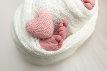 Close-up of unrecognizable cute baby shaking feet while lying in bed, innocence concept