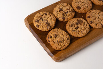 cookies freshly baked on wooden board, gourmet homemade top view, isolated on white background table