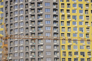 Fototapeta na wymiar urban modern landscape and multi-colored new buildings residential buildings, windows, air conditioners, facades in winter, Biryulovo, Moscow, January 2023.