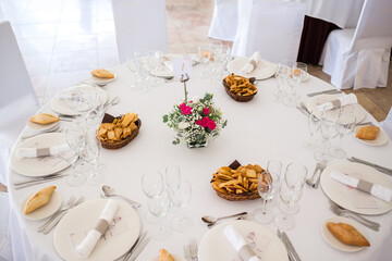 Wedding reception photo. Glasses and flowers on tables. 
