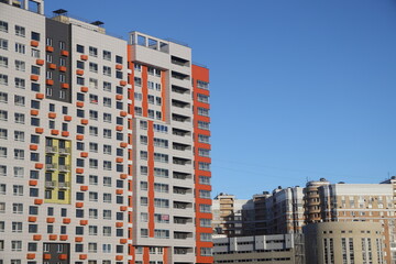 urban modern landscape and multi-colored new buildings residential buildings, windows, air conditioners, facades in winter, Biryulovo, Moscow, January 2023.