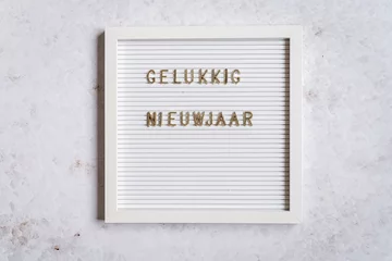 Fototapeten A white letterboard with Gelukkig Nieuwjaar (Dutch for Happy New Year) © Lizzy Komen