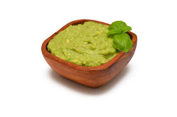avocado guacamole in wooden bowl isolated on white background