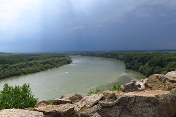 famous castle and ruins of Devin near Bratislava and river Danube in a cloudy summer day with blue, white and grey sky and changing weather conditions in slovakia