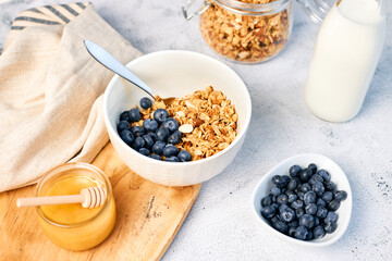 Homemade granola with nuts and fresh blueberries for breakfast. Healthy breakfast. Vegetarian food concept