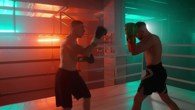 MMA fighters enter the cage ring. Mixed martial arts fight. Cinematic staged fight. Boxing in a ring or cage. Two fighters fight for the right to be the champion.
Boxer in the boxing gym. Bandages his