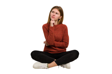 Young caucasian woman sitting on the floor cutout isolated