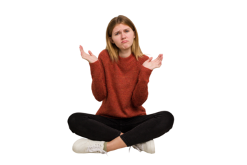 Young caucasian woman sitting on the floor cutout isolated