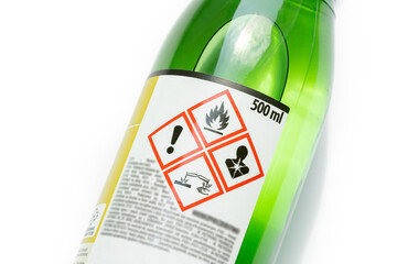 A green bottle of highly corrosive flammable chlorinated rubber nitro solvent with printed on...