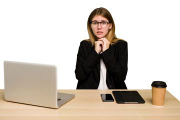 Young business caucasian woman working on her workplace cutout isolated scared and afraid.