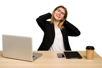 Young business caucasian woman working on her workplace cutout isolated stretching arms, relaxed position.