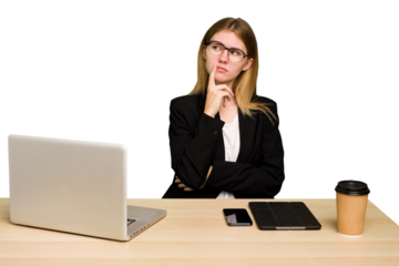Young business caucasian woman working on her workplace cutout isolated contemplating, planning a strategy, thinking about the way of a business.
