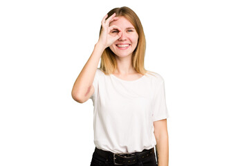 Young caucasian woman isolated excited keeping ok gesture on eye.