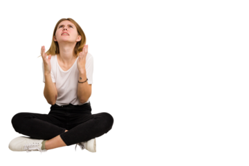 Young caucasian woman sitting on the floor cutout isolated