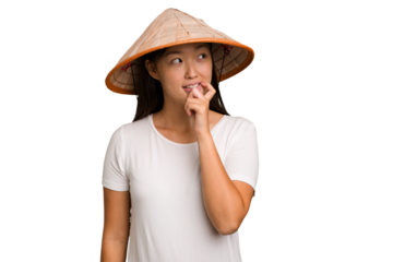 Young asian woman wearing a Vietnamese hat isolated relaxed thinking about something looking at a copy space.