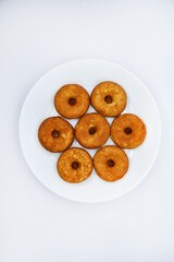 Round shortbread cookies on a plate. Soft sweet cake on a white background. A sweet snack.