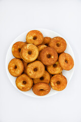 Round shortbread cookies on a plate. Soft sweet cake on a white background. A sweet snack.