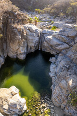 Aerial view of Zorro Canyon Waterfall in the ecological ranch Sol De Mayo on a sunny day in Santiago, Baja California Sur, Mexico