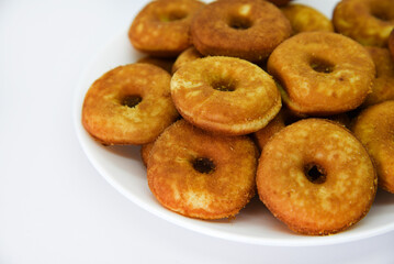 Round shortbread cookies on a plate. Soft sweet cake on a white background. A sweet snack.