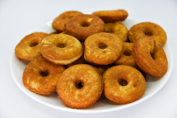Round shortbread cookies on a plate. Soft sweet cake on a white background. A sweet snack.