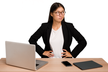 Young business asian woman sitting on a table isolated confused, feels doubtful and unsure.