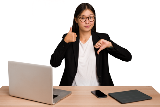 Young business asian woman sitting on a table isolated showing thumbs up and thumbs down, difficult choose concept - Powered by Adobe