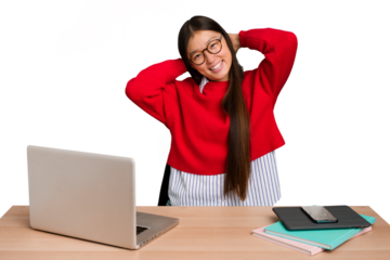 Young student asian woman in a workplace with a laptop isolated stretching arms, relaxed position.