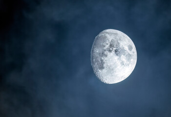 Naklejka na ściany i meble Moon on the cloudy sky close up