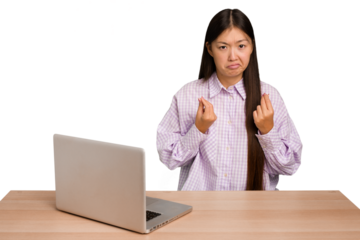 Young student asian woman in a workplace with a laptop isolated showing that she has no money.
