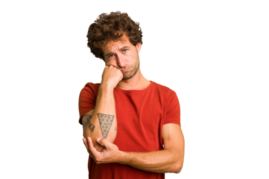 Young curly smart caucasian man cut out isolated who feels sad and pensive, looking at copy space.
