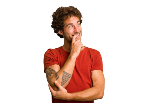 Young curly smart caucasian man cut out isolated relaxed thinking about something looking at a copy space.
