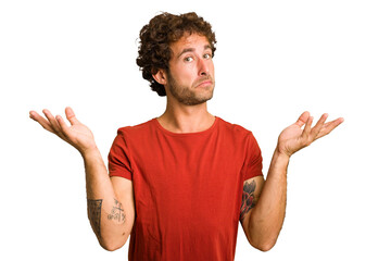 Young curly smart caucasian man cut out isolated doubting and shrugging shoulders in questioning...