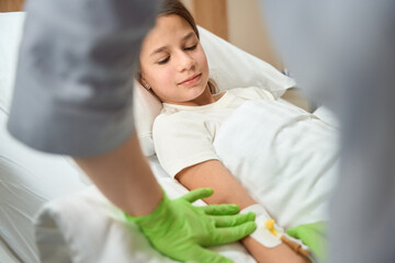 Nurse performs a medical manipulation on a small patient