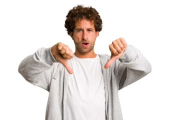 Young curly smart caucasian man cut out isolated showing thumb down and expressing dislike.