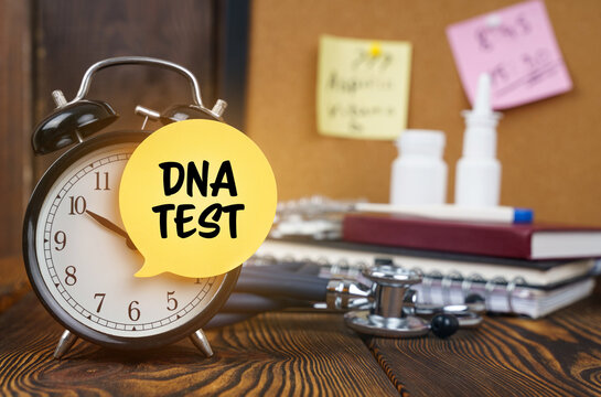 On the alarm clock a sticker with the inscription - DNA test