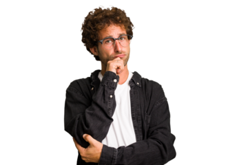 Young curly smart caucasian man cut out isolated thinking and looking up, being reflective, contemplating, having a fantasy.